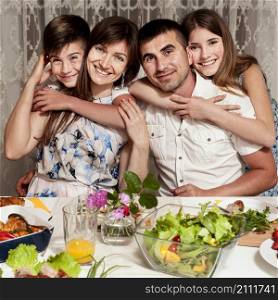 front view happy family posing dinner table