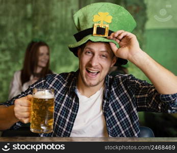 front view happy man with hat celebrating st patrick s day with drink