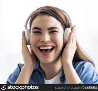 front view happy woman laughing listening music headphones