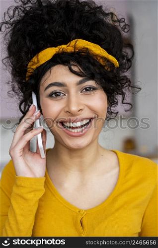 front view happy woman smiling talking phone