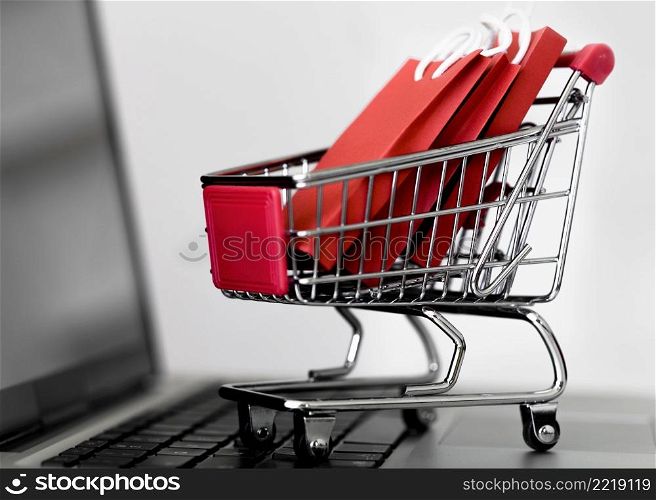 front view laptop with shopping cart bags cyber monday