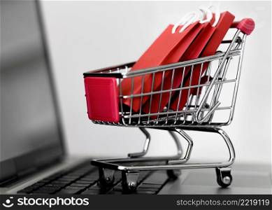 front view laptop with shopping cart bags cyber monday