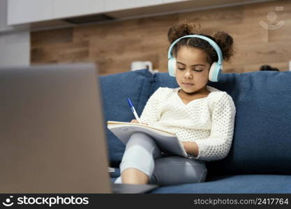 front view little girl during online school with laptop headphones