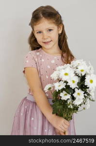 front view little girl holding bouquet spring flowers