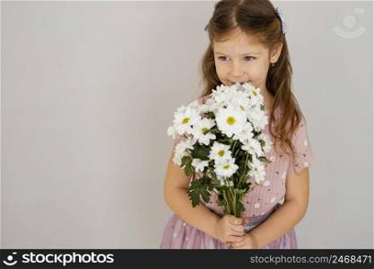 front view little girl holding bouquet spring flowers with copy space