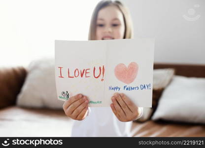 front view little girl holding father s day card as surprise her dad