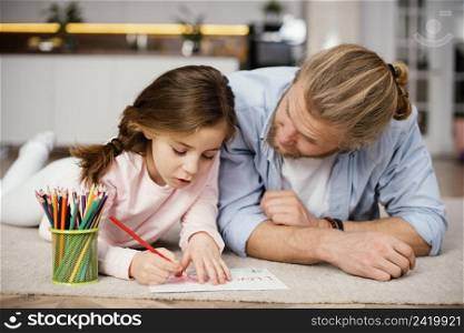 front view little girl spending time with father drawing