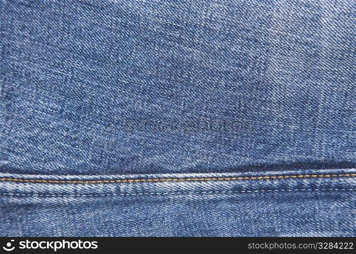 front view, macro of jeans denim and seam, abstract textile background