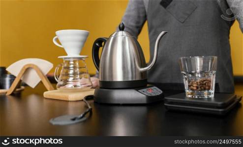front view male barista preparing coffee with kettle filter