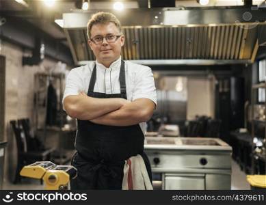 front view male chef posing with arms crossed kitchen