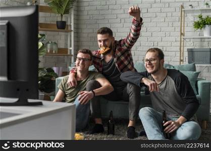 front view male friends having pizza watching sports tv