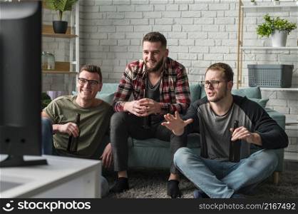 front view male friends watching sports tv