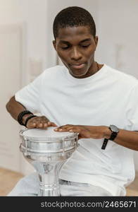 front view male musician home playing drums