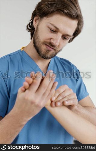 front view male osteopathic therapist checking female patient s wrist