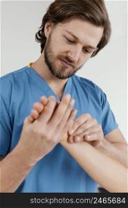 front view male osteopathic therapist checking female patient s wrist