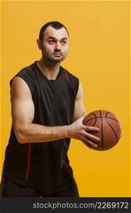 front view male player posing with basketball