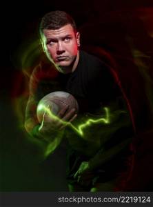 front view male rugby player holding ball with color effect