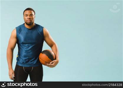 front view man athleisure holding basketball