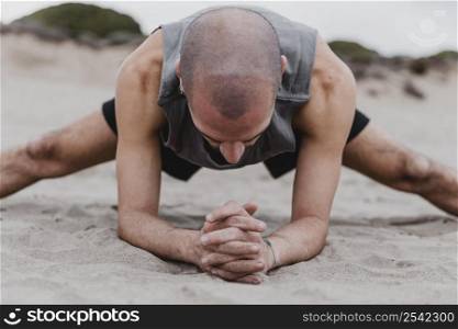 front view man beach exercising yoga positions sand 2