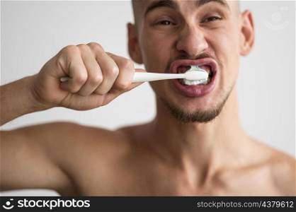 front view man brushing his teeth morning