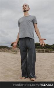 front view man doing yoga outdoors
