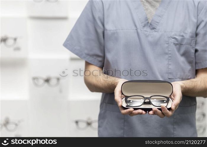 front view man holding pair glasses case