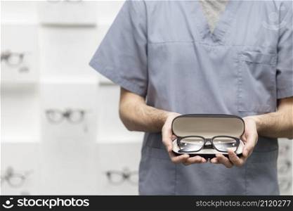 front view man holding pair glasses case
