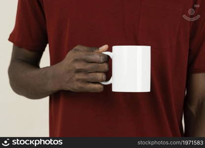 front view man t shirt holding mug. High resolution photo. front view man t shirt holding mug. High quality photo