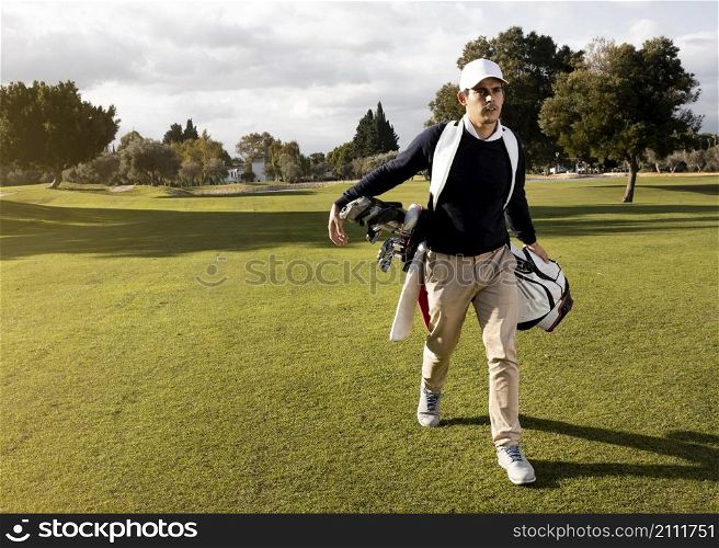 front view man with golf clubs field