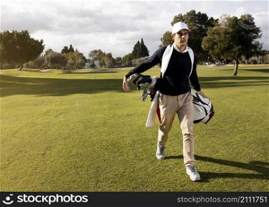 front view man with golf clubs field