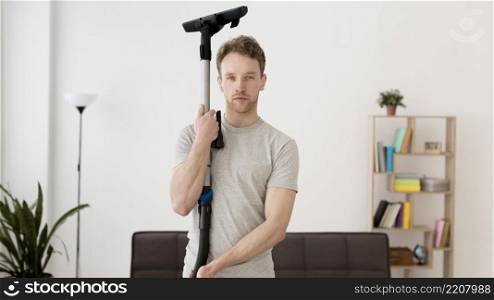 front view man with vacuum cleaner