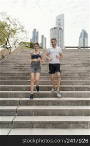 front view man woman exercising stairs