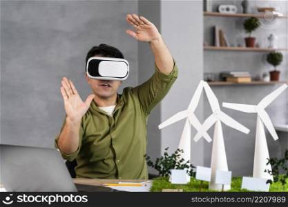 front view man working eco friendly wind power project using virtual reality headset