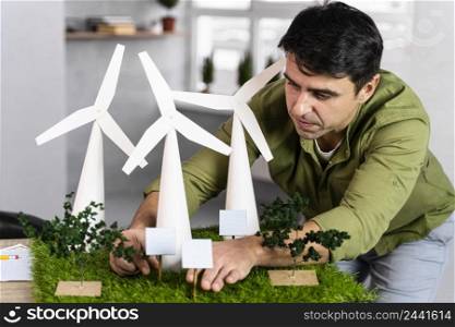 front view man working eco friendly wind power project with wind turbines