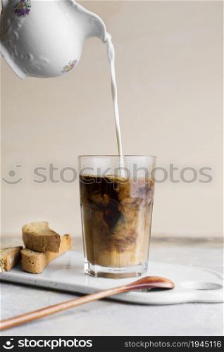 front view milk being poured frappe slices bread with seeds. High resolution photo. front view milk being poured frappe slices bread with seeds. High quality photo