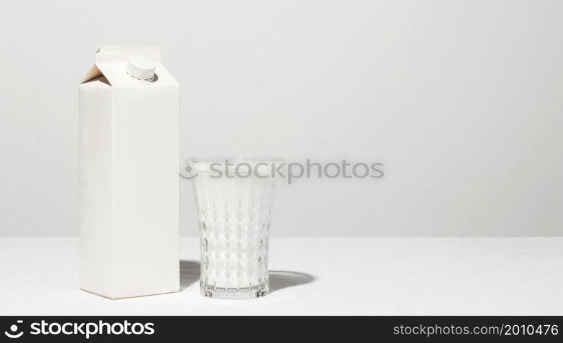 front view milk carton with full glass copy space
