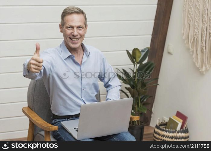 front view modern senior man holding laptop