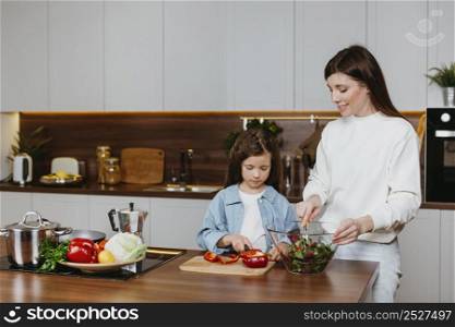 front view mother daughter preparing food kitchen
