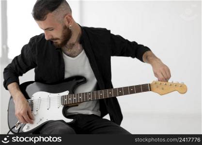 front view musician playing electric guitar