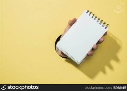 front view notebook with yellow background. Resolution and high quality beautiful photo. front view notebook with yellow background. High quality beautiful photo concept