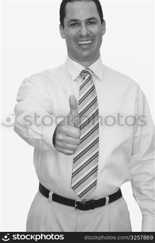 Front view of a businessman making a thumbs up sign