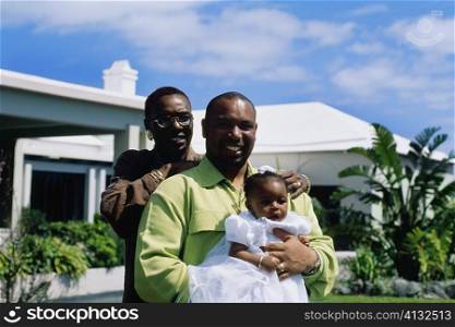 Front view of a couple holding their baby girl, Bermuda
