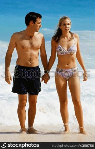 Front view of a couple in swimsuit, Horse-shoe Bay beach, Bermuda