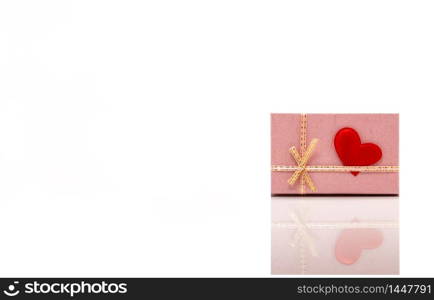 Front View of a Pink Gift Box With a Red Heart Attached to it. Concept of St. Valentine?s Day. Isolated on White Background.