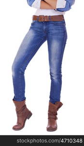 Front view of a standing woman model wearing denim with boots isolated on a white background