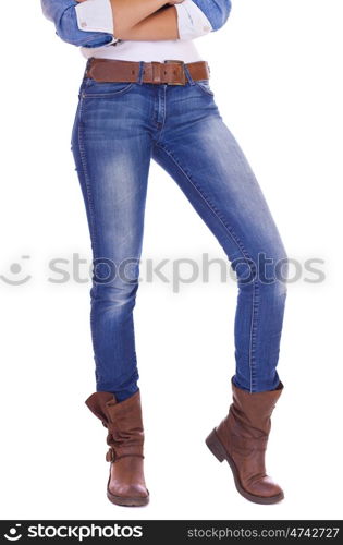 Front view of a standing woman model wearing denim with boots isolated on a white background