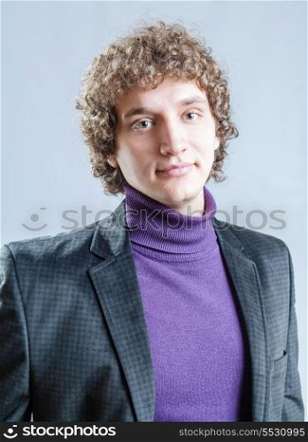 Front view of a young caucasian guy with curly hair