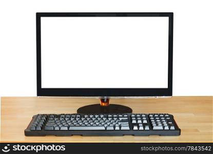 front view of computer black widescreen display with cut out screen and keyboard on wooden table isolated on white background