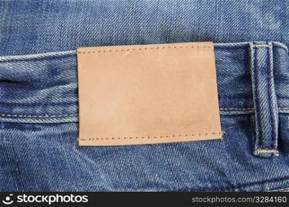 front view of denim label, blue jeans and leather label