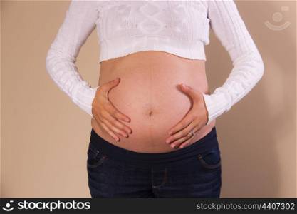 Front view of exposed belly of a pregnant woman